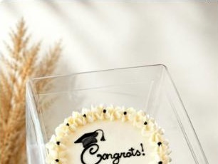 Mini graduation cake with 'Congrats' topper from Youmna Gourmet Confections